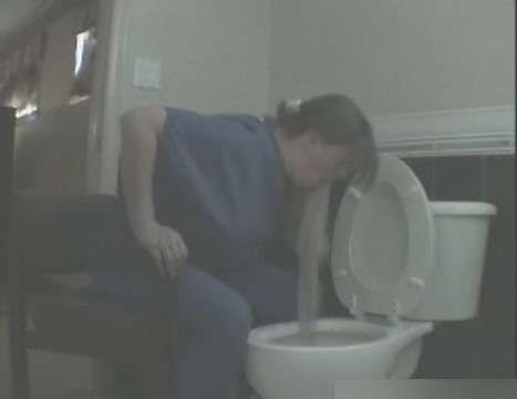 Sitting next to the toilet vomit