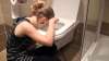 Amelia sits in front of the toilet vomit